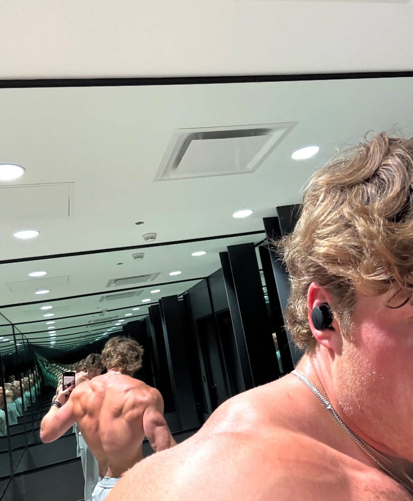 The coach is showing his back muscles.
